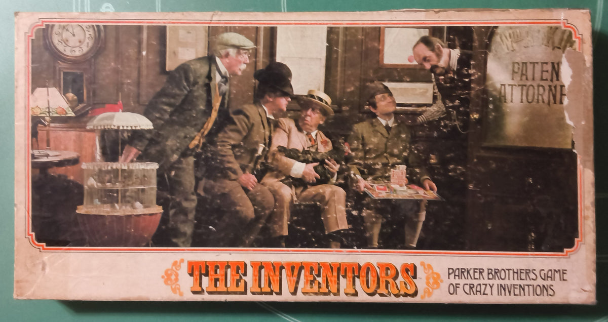 Vintage toy game box for 'The Inventors' by Parker Brothers, featuring a colorful illustration of men inventing on a green cutting mat background.