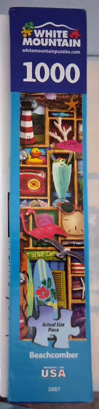 White Mountain 1000-piece jigsaw puzzle box featuring a colorful beachcomber illustration on a blue background.