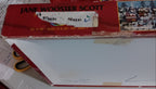box lid featuring a red top band with the text 'JANE WOOSTER SCOTT' puzzle name is 'Pursuits of the Past'