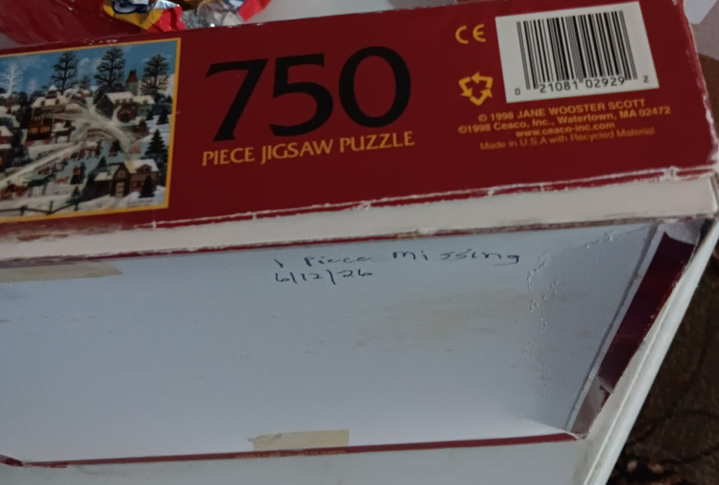 A red 750-piece jigsaw puzzle box of Pursuits of the Past by Jane Wooster Scott