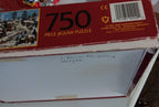 A red 750-piece jigsaw puzzle box of Pursuits of the Past by Jane Wooster Scott