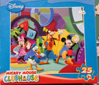 A Disney Clubhouse Mickey Mouse 25-piece jigsaw puzzle box on a green puzzle mat with loose puzzle pieces scattered around.