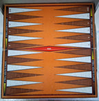 An orange backgammon board with brown and white triangular points, a red center point labeled BAR, and printed side labels for dark and light tables.
