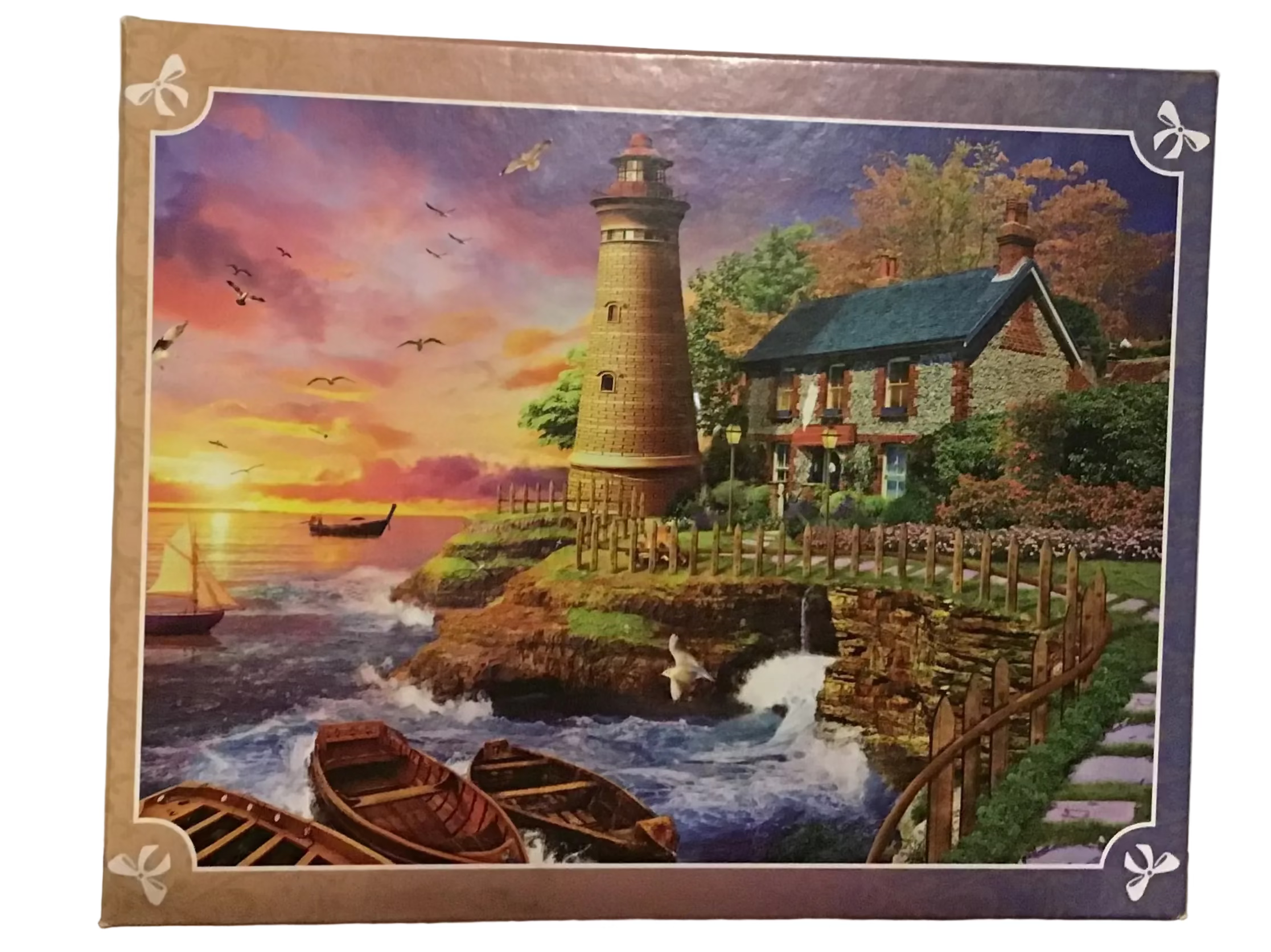 A completed jigsaw puzzle featuring a scenic lighthouse by the sea at sunset, displayed flat on a wooden surface against a white textured wall.