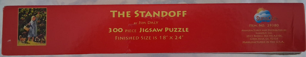 A red jigsaw puzzle box for 'The Standoff' by Jim Daly, featuring a small illustration of a man and woman in a field on the left and product details on the right.