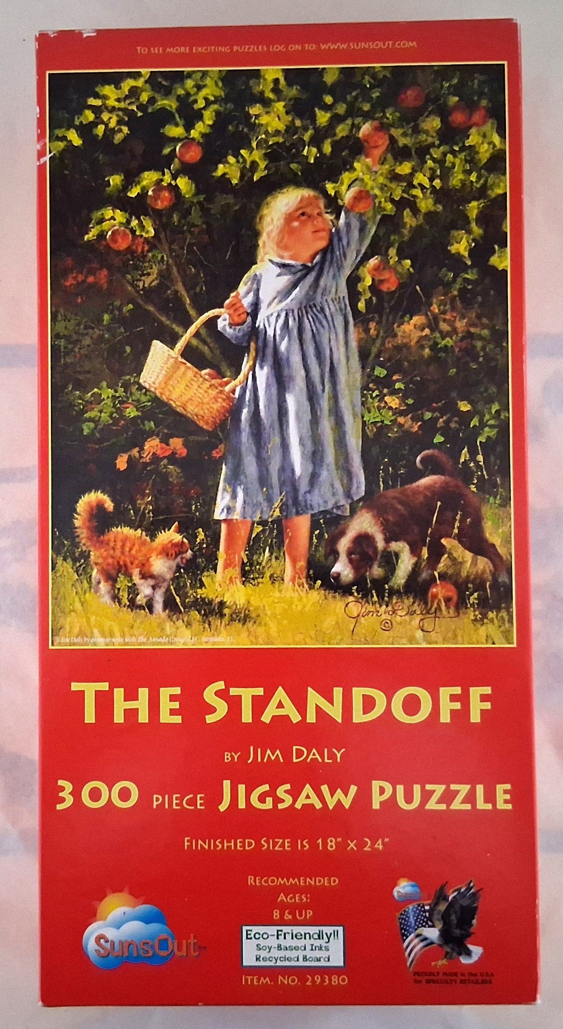 Vintage puzzle box for 'The Standoff' by Jim Daly, a 300-piece jigsaw puzzle. The red box features an illustration of a girl in a blue dress picking apples from an orchard with dogs, and includes a SimOut logo at the bottom.