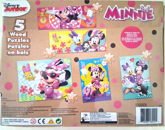 Front of a Disney Junior Minnie Wood Puzzles in box, showing five colorful puzzle panels with Minnie Mouse and Daisy Duck illustrations on a tan background with pink polka dots.