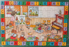 A completed children's jigsaw puzzle featuring cartoon animals in a classroom scene with a colorful alphabet border, placed on a green cutting mat.